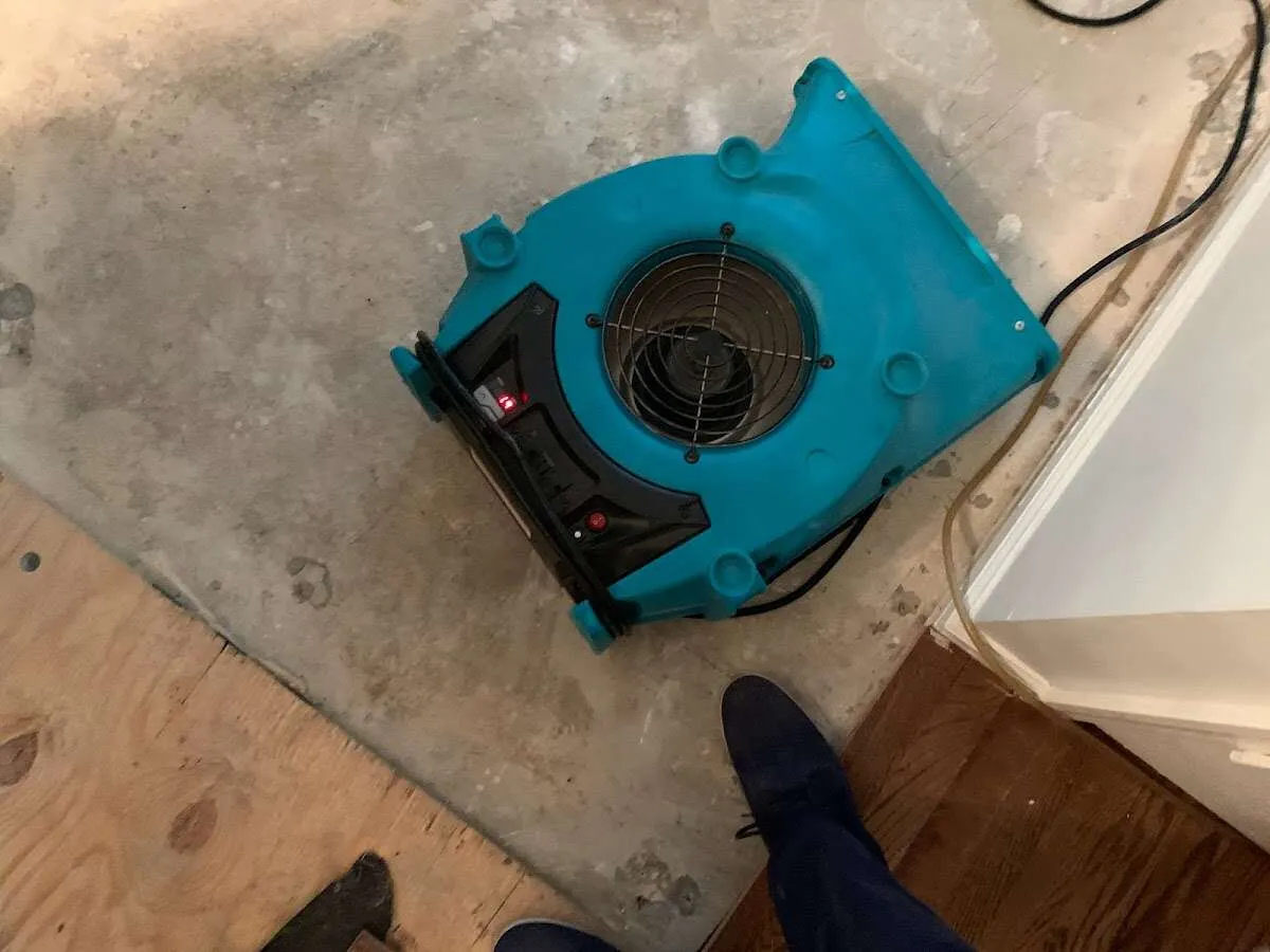 Air mover drying subfloor during Commercial Water Damage Restoration in Rockwall